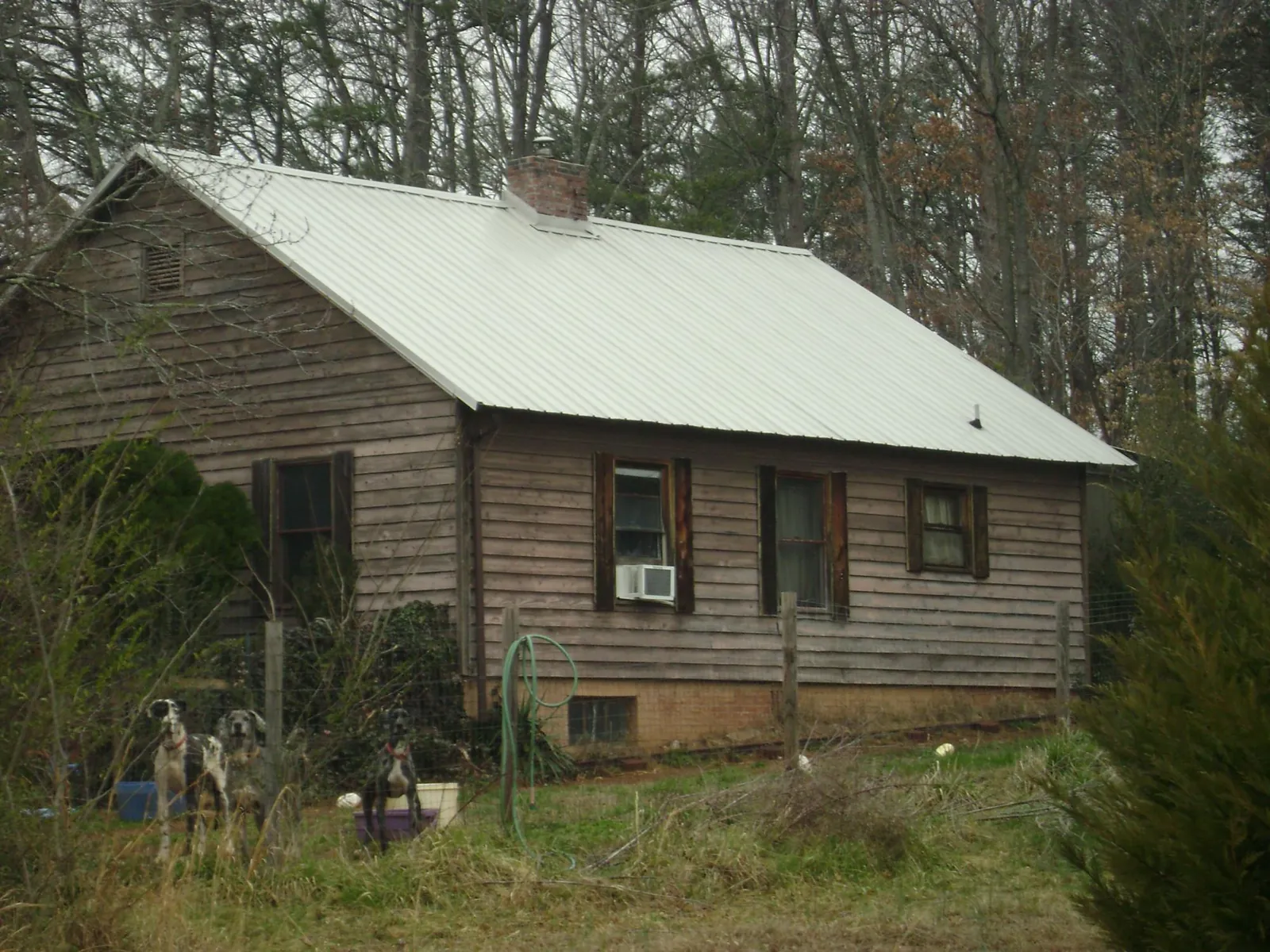 White metal roof on an old wood sided farmhouse, from a Metal Roof Installation job in Bon Aqua